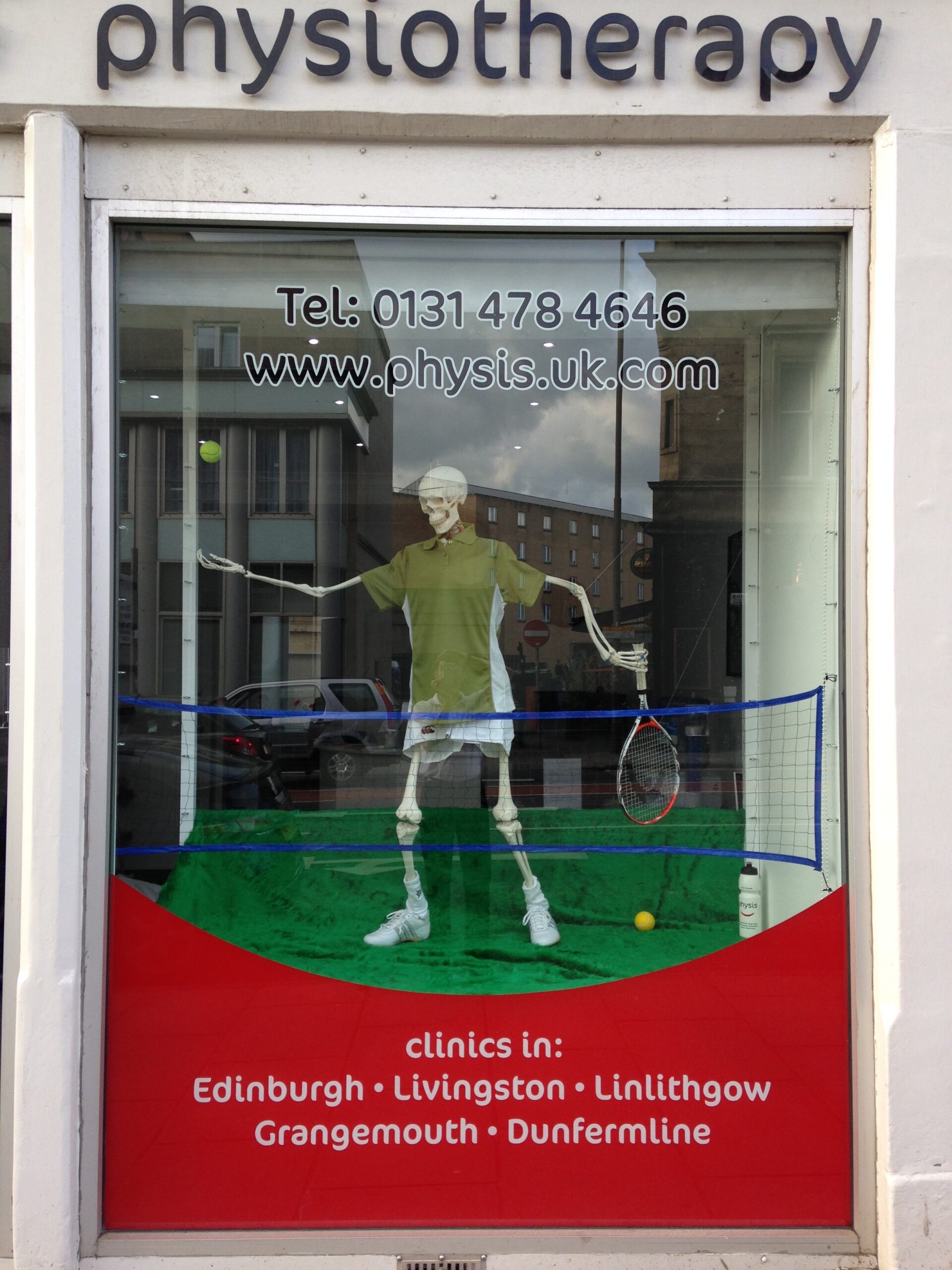 Physis Physiotherapy Window showing a skeleton playing tennis